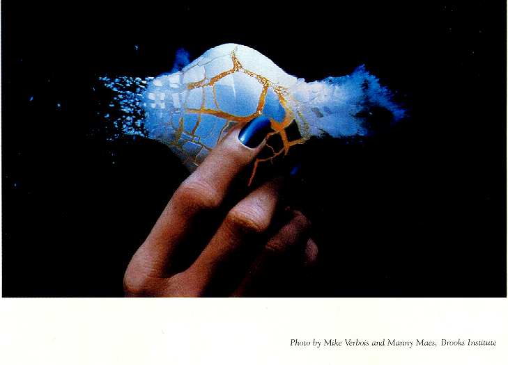 Lady's hand holding egg shot by bullet